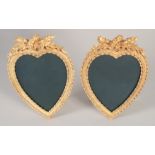 A PAIR OF GILT BRONZE HEART SHAPED PHOTOGRAPH FRAMES.