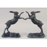 A GOOD PAIR OF BRONZE BOXING HARES on marble bases. 12ins high.