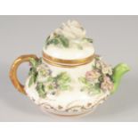 A 19TH CENTURY ROCKINGHAM MINIATURE TEA POT AND COVER encrusted with flowers, printed griffin mark.