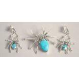 A SILVER AND TURQUOISE SPIDER EARRING AND BROOCH SET.