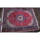 A GOOD LARGE PERSIAN CARPET, crimson ground with floral decoration in a similar blue ground