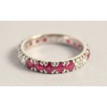 AN 18CT WHITE GOLD RUBY AND DIAMOND FULL ETERNITY RING.