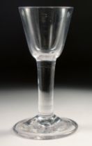 A PLAIN 18TH CENTURY HEAVY WINE GLASS with plain stem. 6ins high.