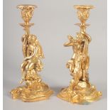 A GOOD PAIR OF GILT BRONZE CANDLESTICKS, the stems with classical figures, semi nude and man