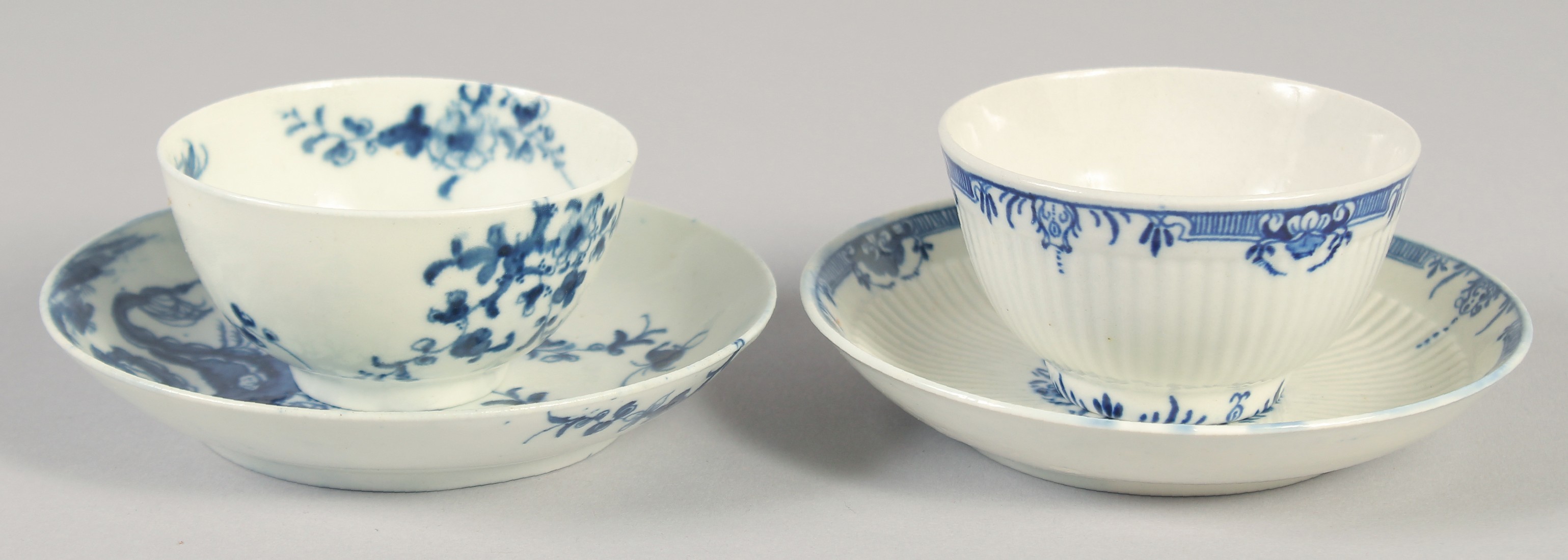 AN 18TH CENTURY WORCESTER TEA BOWL AND SAUCER painted with Prunus Root and a ribbed tea bowl and