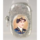 A VICTORIAN ENGRAVED SILVER VESTA CASE with an oval enamel of the jockey, Fred Archer. 1.75ins x