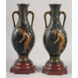 A VERY GOOD PAIR OF BRONZE AND GILDED BRONZE TWO HANDLED VASES with oval panels of a nude and