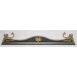 A VICTORIAN STEEL AND CAST IRON SERPENTINE SHAPED FENDER with lion ring handles. 4ft 4ins long,