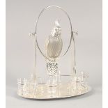 A GOOD SILVER PLATED AND GLASS LIQUEUR SET as a parrot on an oval base with six glasses. 15ins