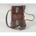 A LEATHER CARTRIDGE CASE 17cm x 11cm, with cross guns in relief and leather strap.