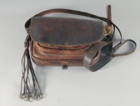 A LEATHER BAG AND STRAP.