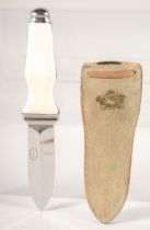 A.G. RUSSELL SOLINGEN, a knife with two-tone handle. 7.5" long, in a leather sheath.