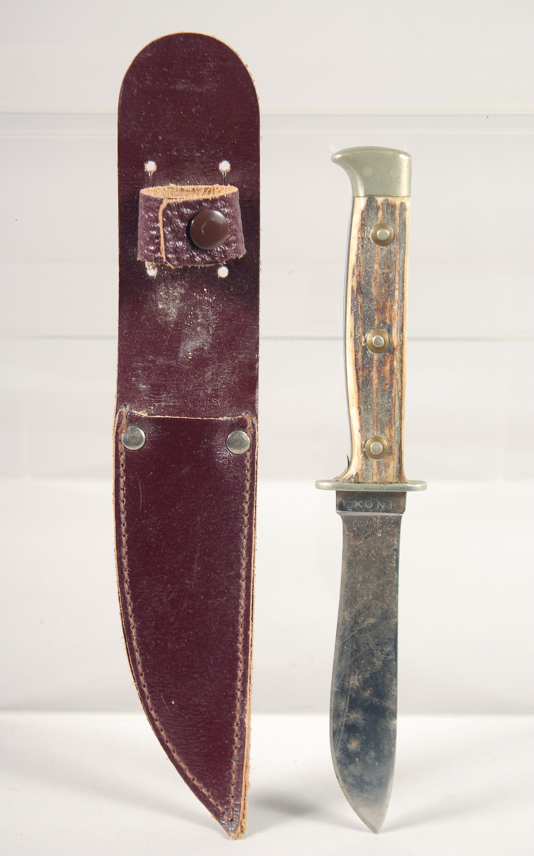 A PUMA NICKER SOLINGEN KNIFE, with antler handle in a leather sheath,7.5" long.