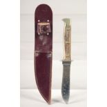 A PUMA NICKER SOLINGEN KNIFE, with antler handle in a leather sheath,7.5" long.