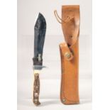 A PUMA WHITE HUNTER 6377 PUMASTER STEEL, with antler handle, 10.5" long, in a leather sheath.