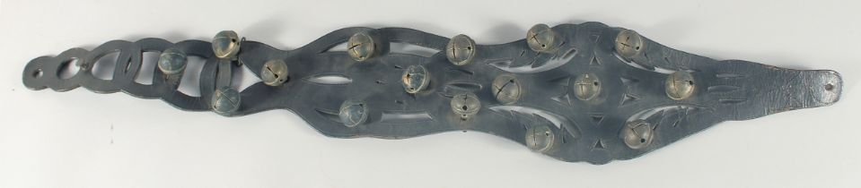 A HORSES LEATHER GIRTH STRAP, with fifteen brass bells, 40cm long.