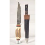 A PUMA KNIFE, with antler handle, in a leather sheath, 7.5" long.