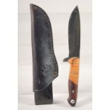 A JAGANICKER OLIVE / COCO KNIFE, in a leather sheath, 8.5" long.