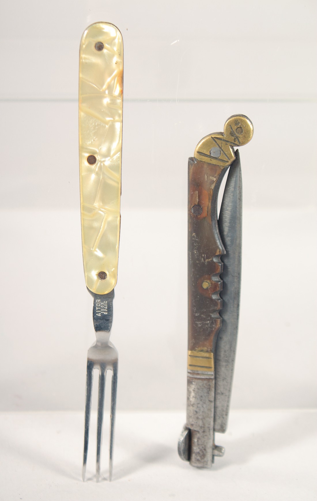 A MOTHER OF PEARL TRAVELLING FORK "AITOR", and a folding knife.