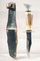 A SOLINGEN GERMANY KNIFE, with antler handle, 9" long, in a leather sheath.