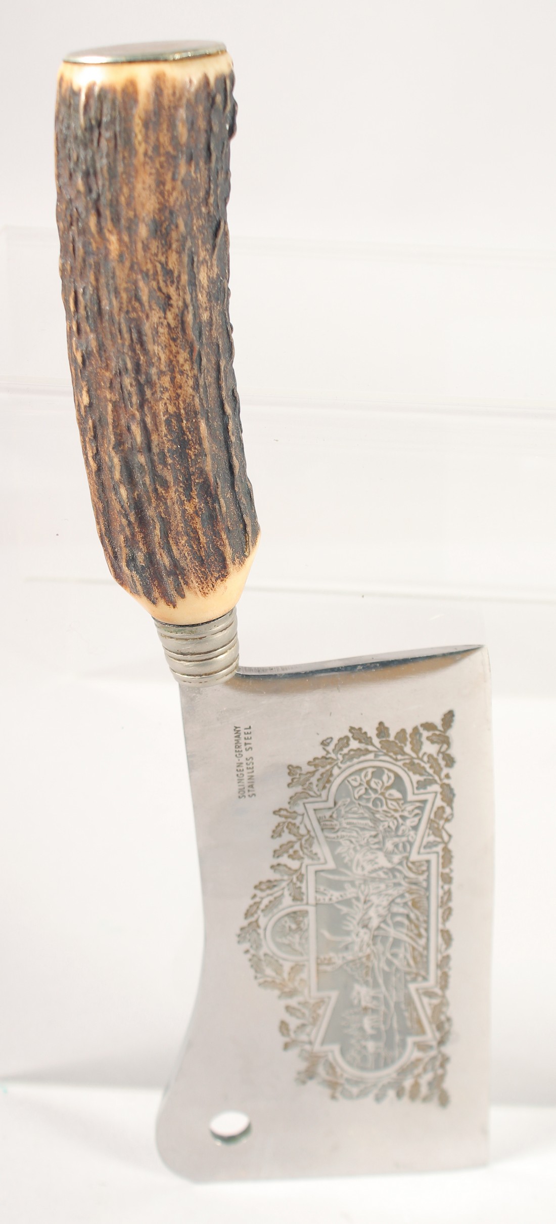 A SOLINGEN STAINLESS STEAL CLEAVER, the blade engraved with a deer, with an antler handle, 10.5"