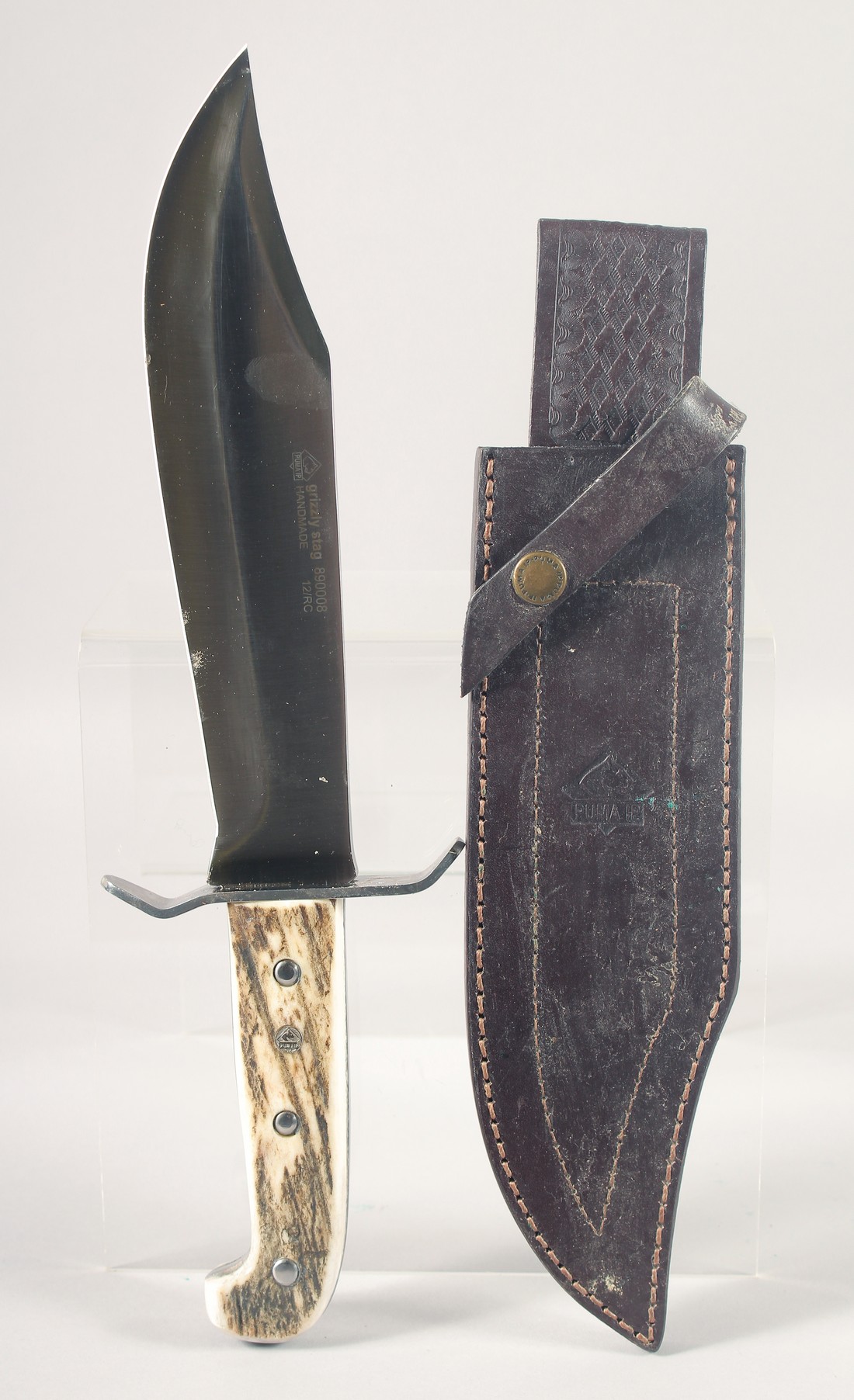 A GRIZZLY STAG 89008 PUMA KNIFE, with antler handle, 13" long in a leather scabbard.