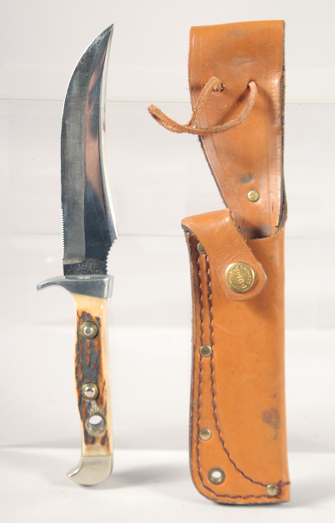 THE 637 PUMA-SKINNER KNIFE WITH SUPER KEEN CUTTING STEEL, with antler handle, in a leather sheath,