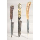 THREE VARIOUS KNIVES, with antler handles, 8" long.