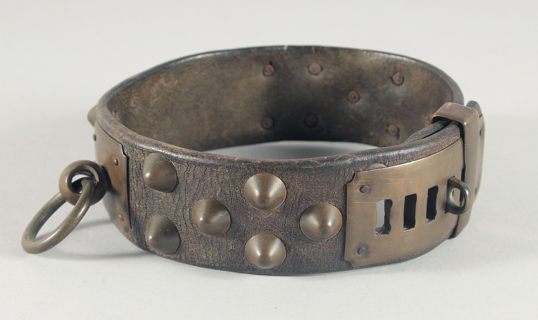 A 17th CENTURY LEATHER STUDDED BRASS DOG COLLAR, with six brass settings, stamped, possibly