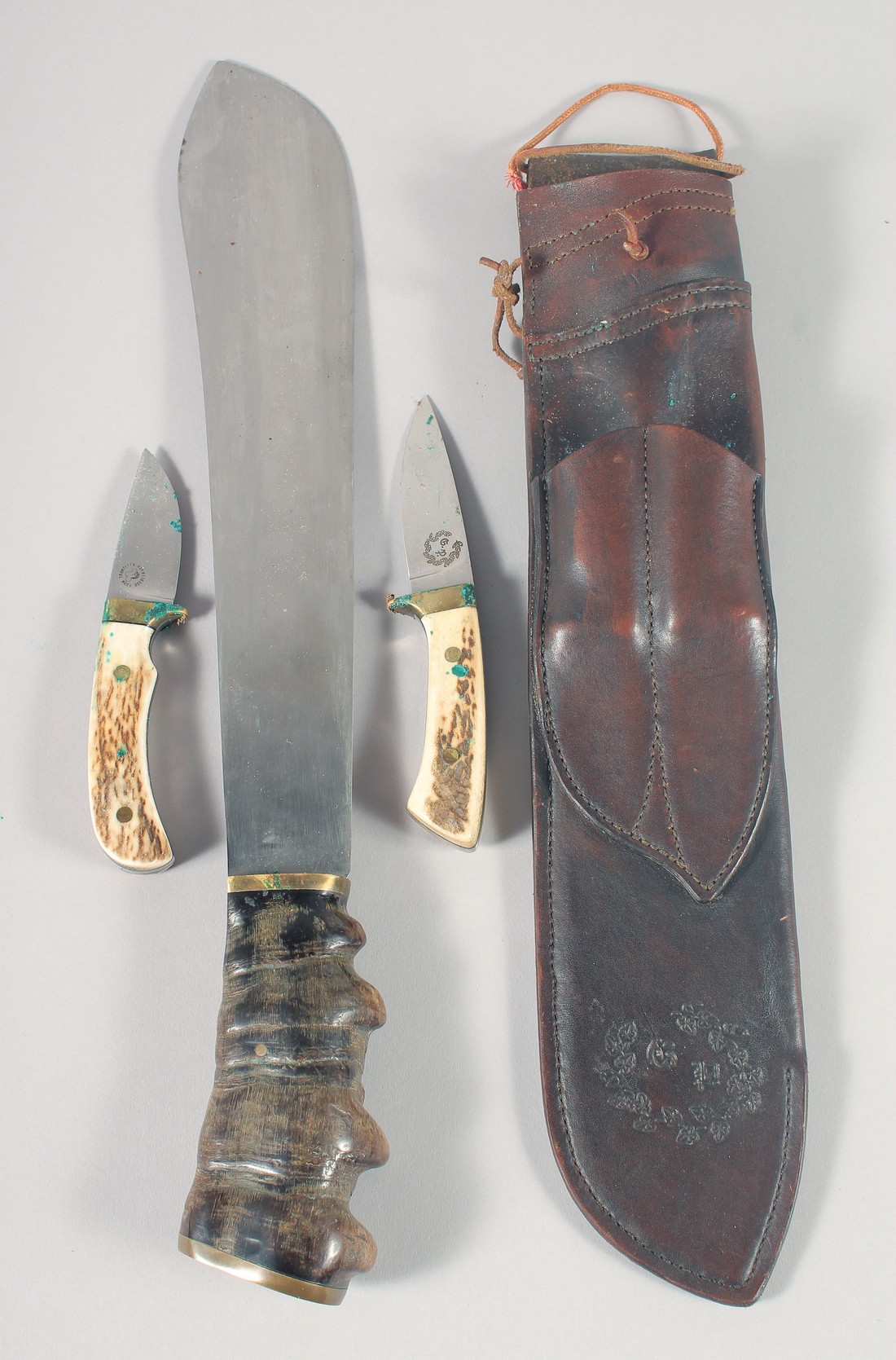 A SUPERB J.J.B. 1943 MACHETE, with fossilized wood handle, 20" long, in a leather scabbard.