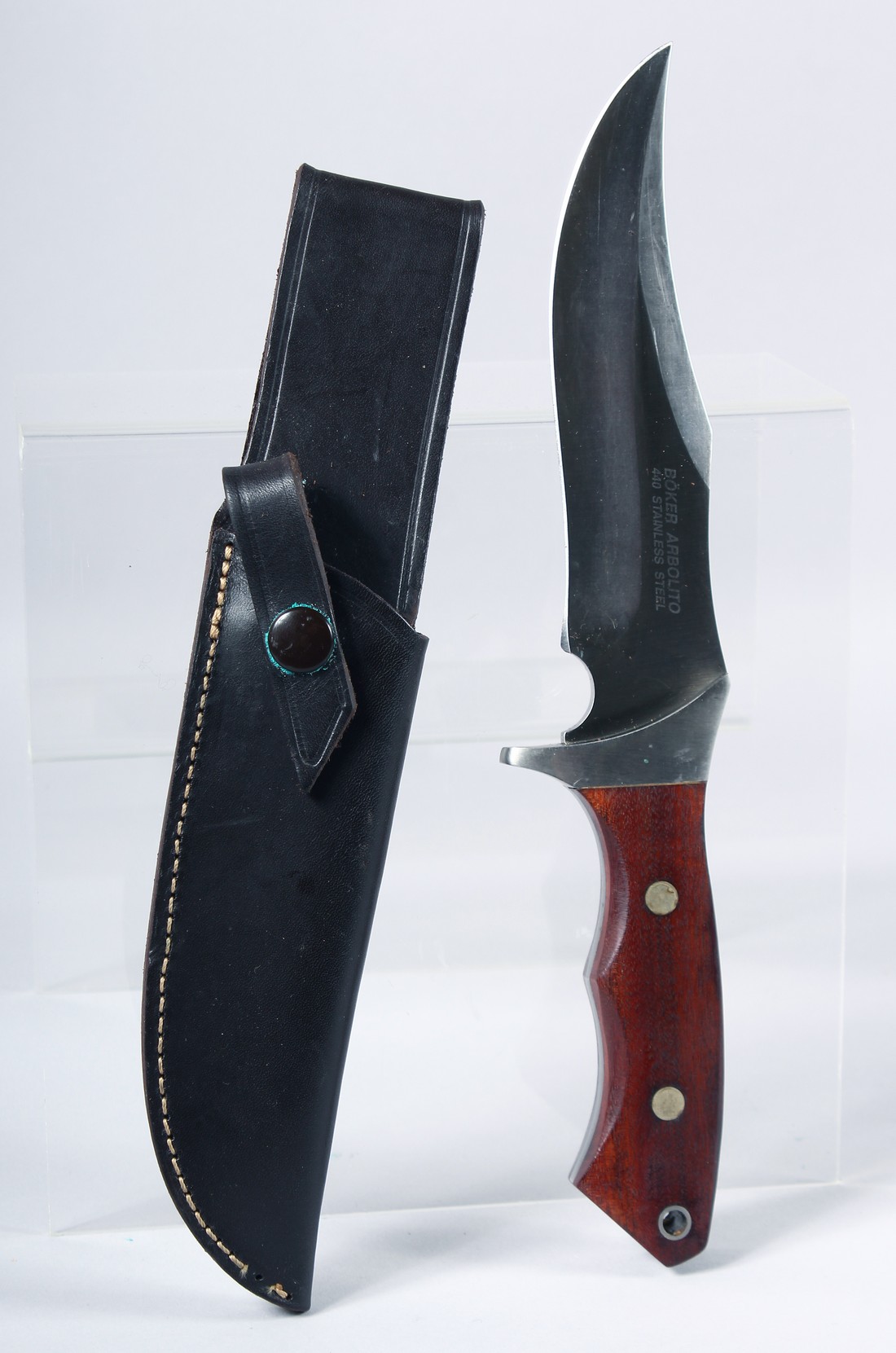 A BOKER 440 STAINLESS STEEL KNIFE, with a wooden handle, 11" long, in a leather case.