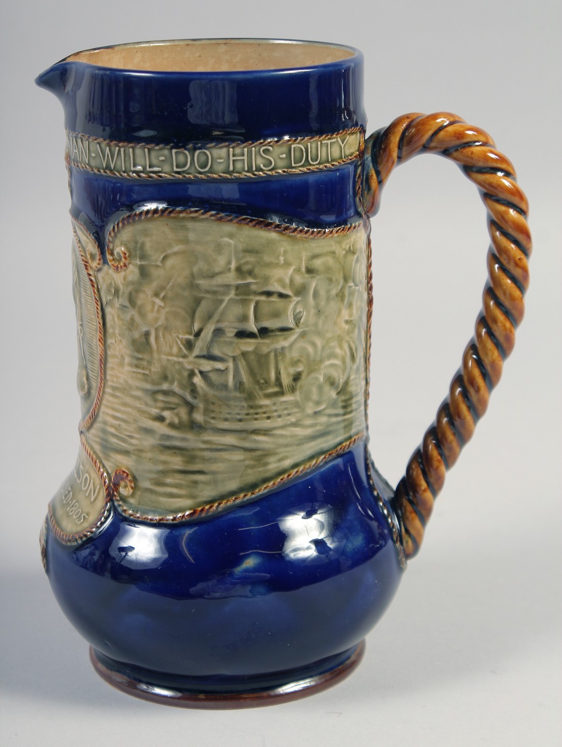 A ROYAL DOULTON STONEWARE JUG, "Lord Nelson born 1758 died 1805", 8".