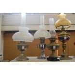 Four various oil lamps.