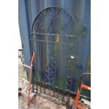 A wrought iron arch shaped gate 5' 5.5" high x 2'8" wide.