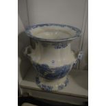 A large blue and white twin handled urn.