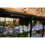 A large quantity of blue and white china to include egg cups, toast rack, mantel clock etc.