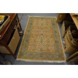 A cream ground rug with a floral decoration 6' x 3' 10".