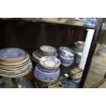 A quantity of blue and white plates, saucers, bowls.