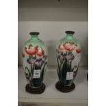 A pair of cloisonne vases on stands (some damage).