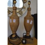 A pair of turned wooden table lamps.