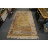 A Chinese gold ground rug 7' 4" x 4' 1".