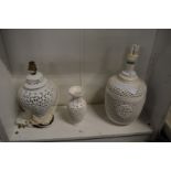 Two blanc de chine lamp bases and a similar vase, all with pierced decoration.
