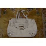 A Ladies cream colour handbag.