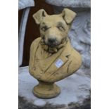 An amusing garden sculpture modelled as the bust of a dog wearing a jacket.