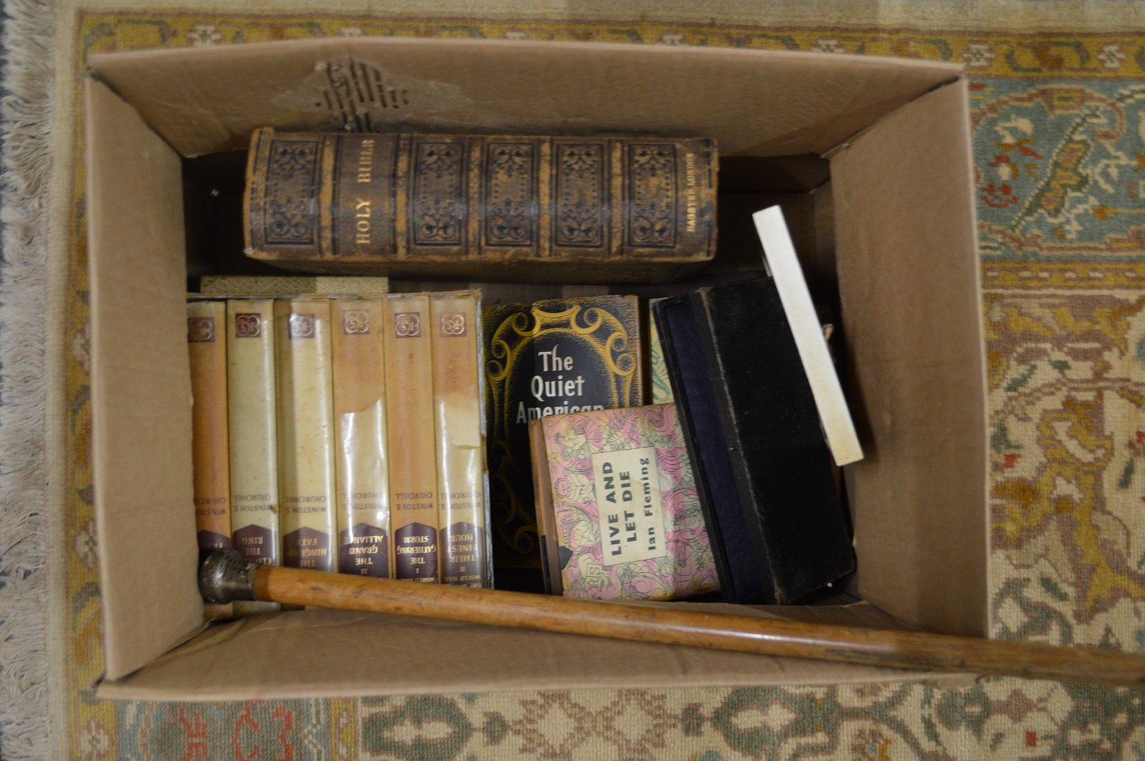 A box of books and collectables.