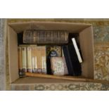 A box of books and collectables.