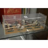 A Die cast set of twelve mounted cavalry, in a perspex case.