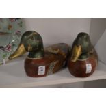 A pair of carved wood and painted models of ducks.