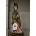 A Japanese cloisonne model of a woman.