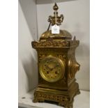 A decorative brass mantel clock.